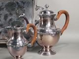 two silver teapots and a silver tray on a table