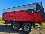 a red dump truck that is parked on the side of the road