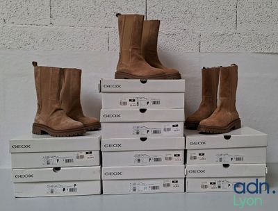 several boxes of shoes are stacked on top of each other