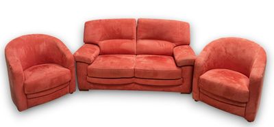 three red chairs and a couch in a room with a white background