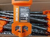 a box full of drill bits in the middle of a pile