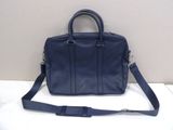 a blue leather handbag sitting on top of a white table
