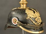 an old helmet with a gold eagle on the top of it