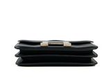 a close up of a black purse on a white background