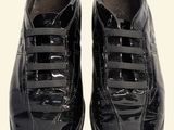 pair of black shoes with laces on them on a white surface