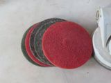 four red and green discs on a table next to a grinder