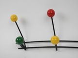 three different colored pins on a white surface with a white background