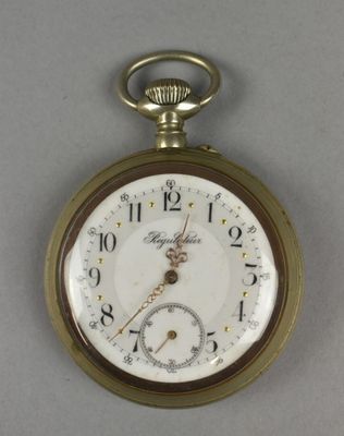 a gold pocket watch with roman numerals on the face