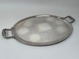 an oval silver tray with handles and handles on a white surface