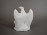 a white statue of a bird on a table