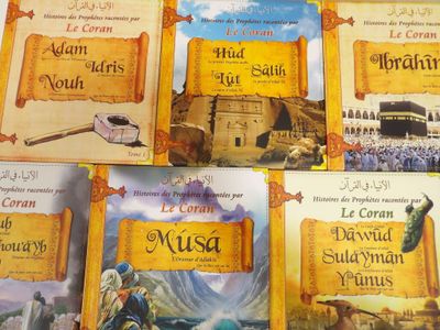 several children ' s books are lined up on a table in front of each other