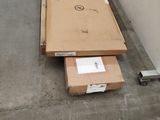 a box that is sitting on the ground next to a wall