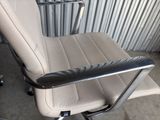 a chair that is sitting in front of a metal wall