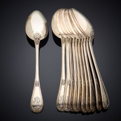 a lot of silver spoons and spoons on the table