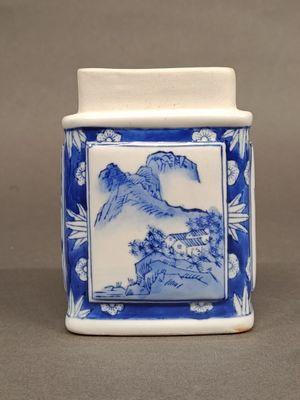 chinese blue and white porcelain jar with a mountain scene on the lid