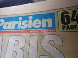 newspapers are stacked on top of each other on a table