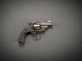 an old gun on a gray surface with a black background