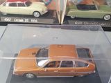 three different models of cars are in a clear box on a table