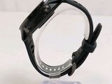 a close up of a watch on a clear stand
