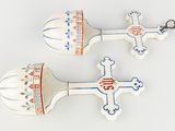 two white spoons with designs on them on a white surface
