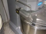 a mixer sitting next to a mixer on a counter