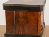 a small wooden box with a design on it