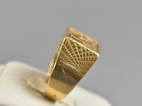 an image of a gold ring sitting on top of a white box