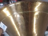a large brass trumpet that is on display in a store