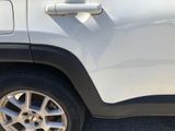 a close up of a car door handle and tire