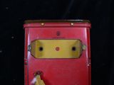 a small red box with a banana hanging from it