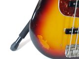 a close up of a bass guitar on a white surface