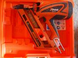 an orange box with a stapler and a nail gun in it