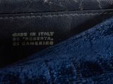 the inside of a black purse with a label on it