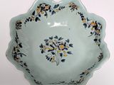 a blue bowl with yellow and blue flowers on it