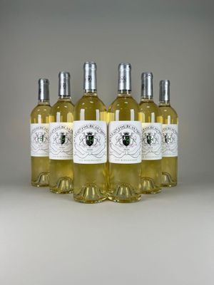 four bottles of white wine sitting on top of a table