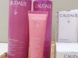 three bottles of caudalie are sitting on a table next to a box of soap
