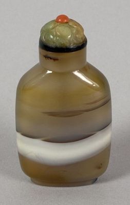a small glass vase with a green and white stripe around it
