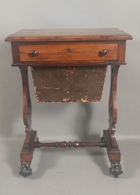 a small wooden table with a magazine rack on it