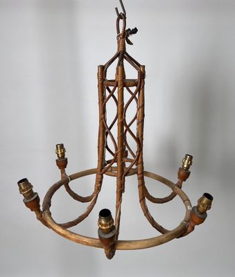 an image of a chandelier made out of bamboo sticks and brass fittings