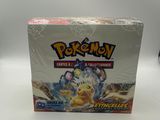 a box of pokemon trading cards on a white surface