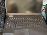 a laptop computer sitting on top of a table next to a keyboard