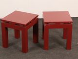 two red tables sitting next to each other on the floor