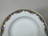 a white plate with blue and yellow designs on it