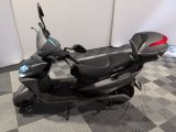a scooter that is parked on a checkered floor