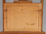 a small wooden easel with a painting on top of it