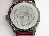 a close up of a watch on a white surface