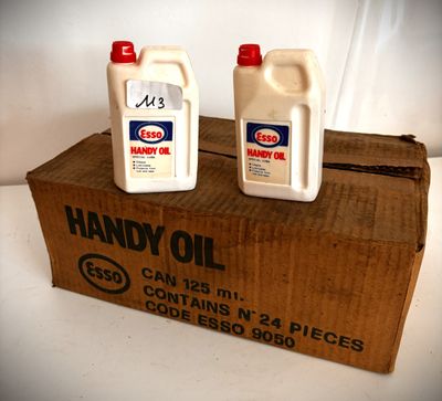 deux bouteilles d'huile posées sur une boîte en carton