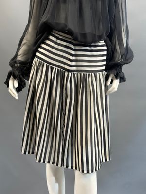 a black and white striped skirt with a sheered blouse