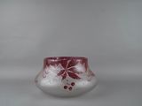 a glass vase with a red and white design on it