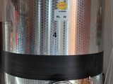 an image of a large stainless steel tank in a garage